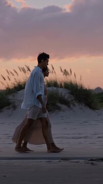 Romantic couple walking on the beach at sunset