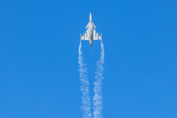 Fighter Jet Climbing with Vapor Trail in Sky