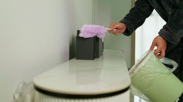 Use a duster to wipe the dust off the tabletop. Housekeeping service, House hygiene clean.
