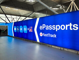 Blue ePassports FastTrack Sign in Airport Terminal for Seamless Travel © Alexey Fedorenko