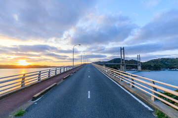 初春の呼子大橋と夕日　佐賀県唐津市　The Yobuko Bridge and sunset in early spring. Saga Pref, Karatsu City.　 © M・H