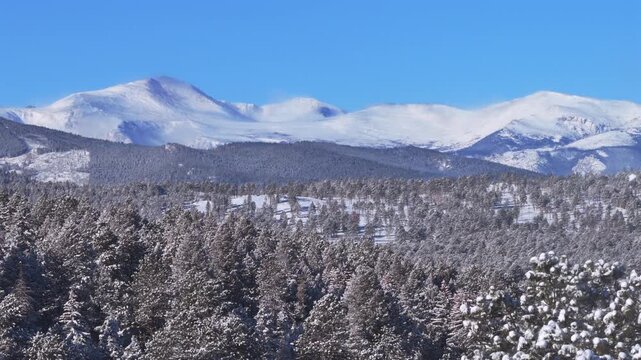 Winter Mt Blue Sky Mount Evans Front Range Rocky Mountains aerial drone Colorado morning deep fresh snow sunny blue sky Evergreen Conifer Denver prominent snow capped peak snowy forest trees circle