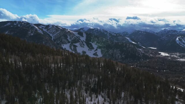 Aspen Mountain ski downtown afternoon sunset clouds AJAX Aspen Highlands Ski resort Maroon Bells Wilderness aerial drown ski trail runs fresh snow Rocky Mountains peaks chairlift gondola upwards motio