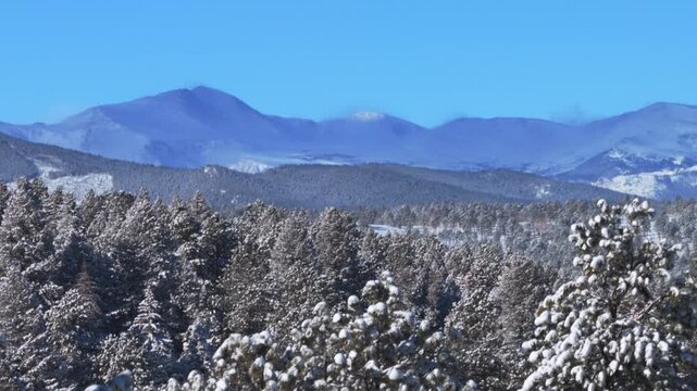 Winter Mt Blue Sky Mount Evans Front Range Rocky Mountains aerial drone Colorado morning cloud shade snow sunny blue sky Evergreen Conifer Denver prominent snow capped peak snowy forest trees zoom in