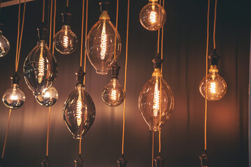 Fototapeta premium Background light bulb blurry background interior design bar table chair windows with copy space. Blurred background cafe coffee shop restaurant in shopping mall with light bokeh business event