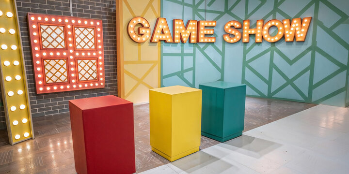 Colorful retro television game show studio stage with bright lights podiums vibrant entertainment set design