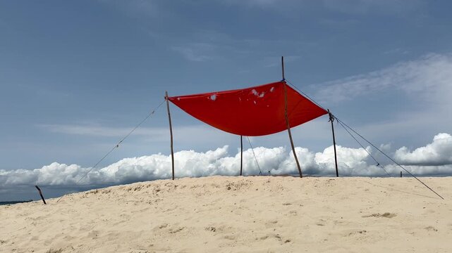 Abstract simple red fabric as a sunshade at Kwale Sandbank. Zanzibar, Tanzania.