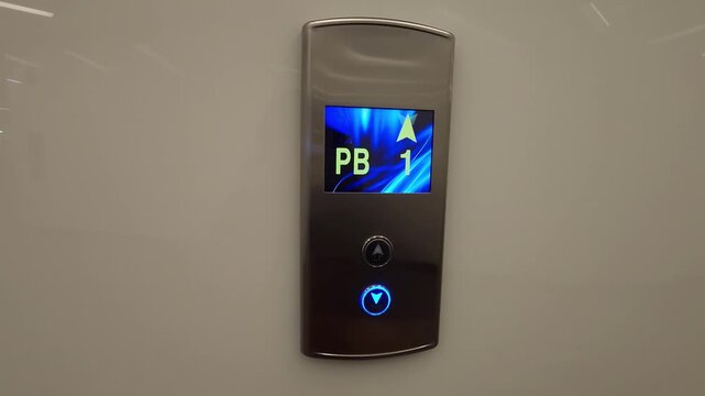 Female hand pressing elevator button with braille for visually impaired people