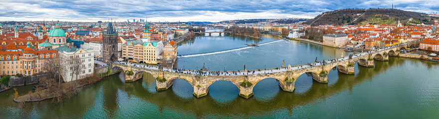 Fototapeta premium Charles Bridge Prague panorama over Vltava River and historic city skyline