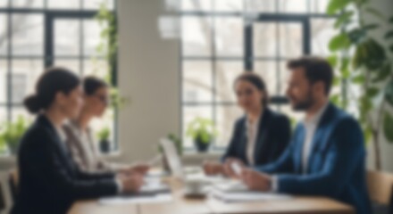 Fototapeta premium Blurred business meeting with professionals discussing work at table in modern office with laptop documents teamwork workplace background
