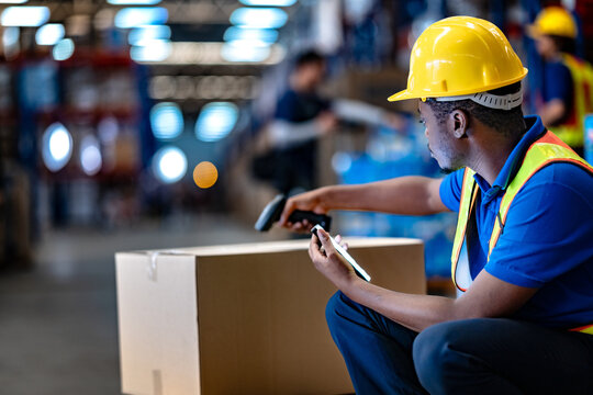 Modern supply chain technology in action. Focused male employee working with digital device and scanner to control warehouse cargo logistics.