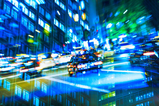 Multiple exposure of Tokyo business district at night, representing the dizzying pace of city life.