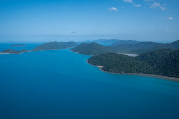 Fototapeta premium Whitsunday islands aerial view showing tropical forest and clear ocean