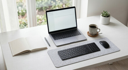 Fototapeta premium Bright and organized home office setup with a modern laptop, external keyboard, and mouse, perfect for remote work and focused productivity near a sunlit window
