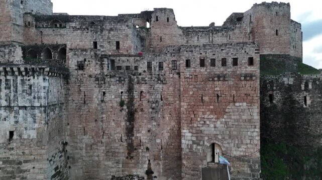 drone close up of ancient masonry and defensive structures of the historic Krak des Chevaliers fortress in Syria