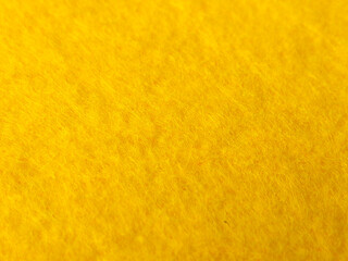 A high-resolution macro close-up showcasing the vibrant yellow texture of a felt or fleece fabric © Mohd Azrin