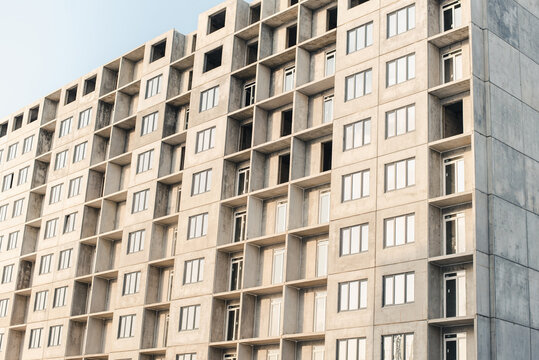 facade of a building. New building. House under construction. Construction site.