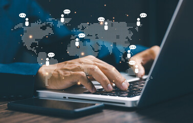 Fototapeta premium Business professional working on laptop with digital world map and communication icons connecting people globally. Concept of global business network, online communication, remote collaboration