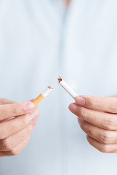 Man hand break cigarette for World No Tobacco Day concept, quitting smoking to prevent Lung Cancer, COPD, Emphysema and Tuberculosis disease. healthy lifestyle resolution, stop nicotine addiction