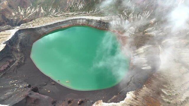 Mist Flowing Over Okama Crater Lake | Japan - 4K Aerial Video
