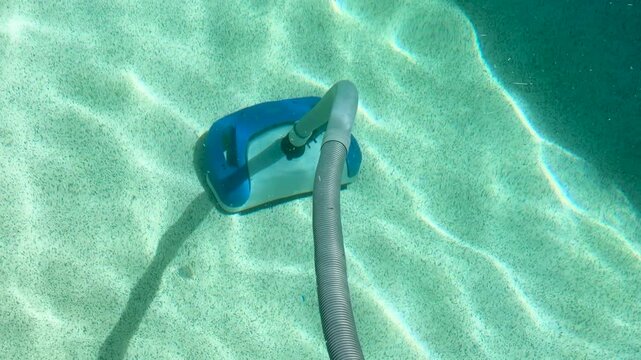 Automatic Robotic Pool Cleaner Moving Across the Bottom of a Swimming Pool