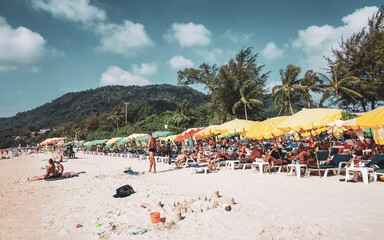 Fototapeta premium Tropical Patong Beach Phuket Thailand tourists people parasol palm trees.