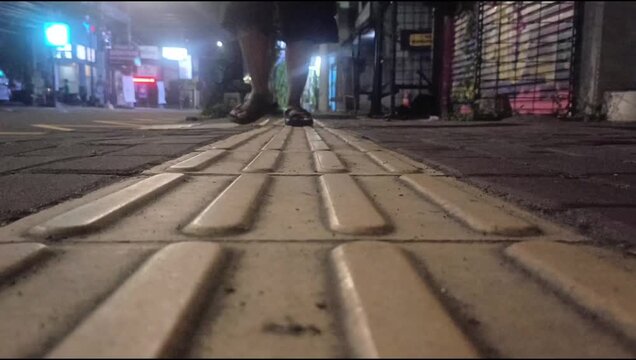 people walking on the street at night