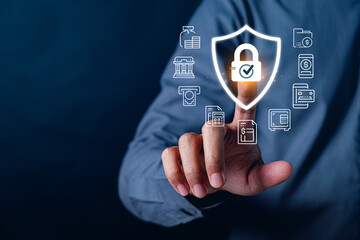 Businessman pressing digital shield with lock and financial service icons, representing cybersecurity protection for banking transactions, fintech security, digital payments, and secure financial data