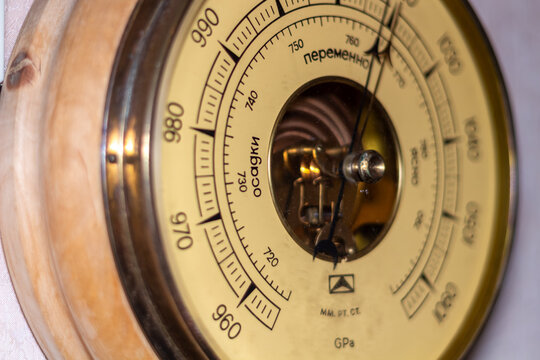 Antique barometer instrument measuring atmospheric pressure weather forecasting device in wooden case