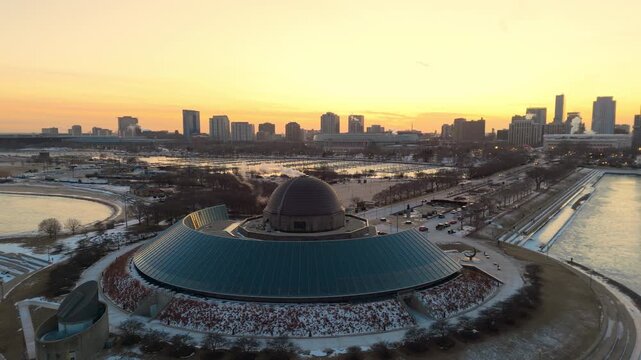 Drone aerial view of Adler Planetarium and Chicago skyline during winter with severe frost and icy landscape along Lake Michigan. Close up. 