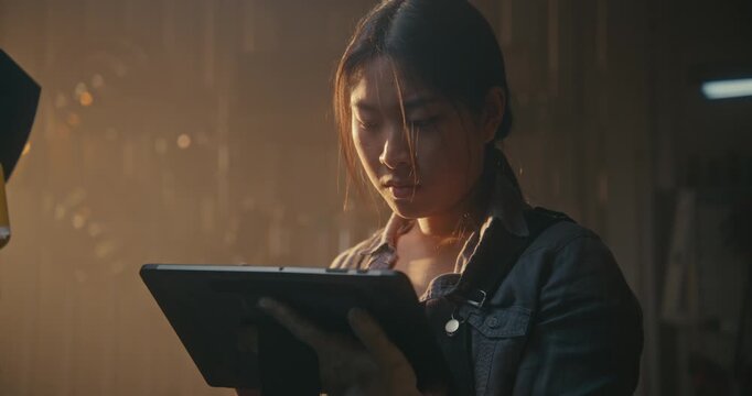 Skilled Female Uses Digital Tablet Communicate With Car ECU, Resetting Service Intervals, Clearing Error Codes After Successful Fix. Modern Paperless Workflow, High Precision Automotive Maintenance.