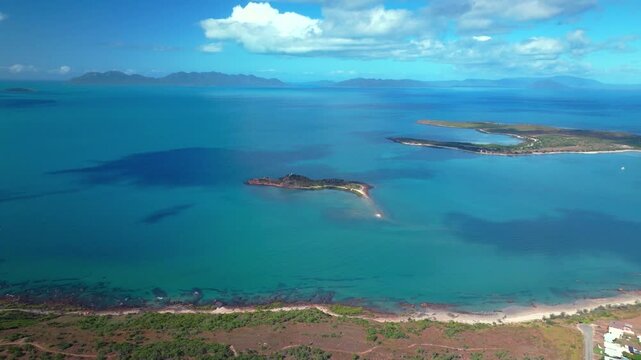 Bowen Proserpine Horseshoe Bay Australia QLD aerial drone landscape Great Barrier Reef ocean Whitsunday Region sunny blue sky Coral Sea Marina harbor view landscape Port Airlie Beach forward pan up