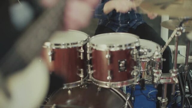 Male hands Close-up of a drum kit on a dark stage professional drummer musician play drum cymbal with drumstick in studio beat Drummer lifestyle