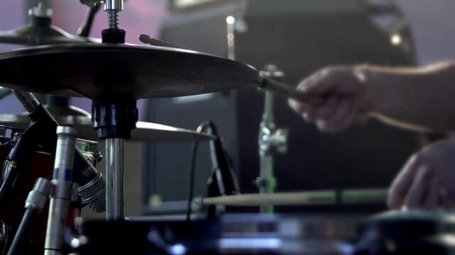 Close up Drummer playing on drum set drum Drum Cymbals black clothes sits behind a drum kit and beats drumsticks on different cymbals hihat rythm