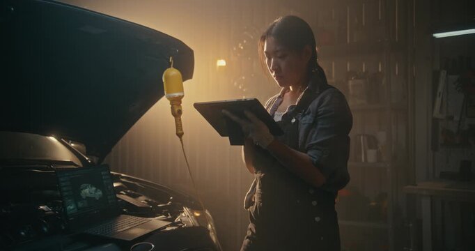 In Advanced Repair Setting, Female Integrates Laptop Diagnostics and AI Powered Tablet Analysis. Girl Evaluates Electronic Systems, Compares Metrics, Efficiently Solves Automotive Technical Issues.