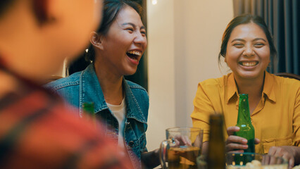 Group of multiethnic adult Asia friend drink alcohol beer bottle glass and fun talk laugh enjoy...