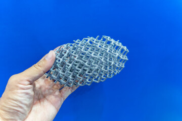 hand with metal products made by metal 3D printing. Modern additive technology.