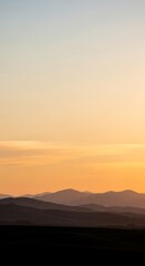 Fototapeta premium Golden Hour Light Over a Tranquil Mountain Vista.