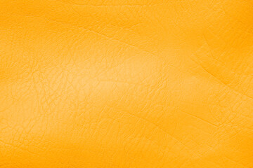 Naklejka premium Vibrant golden orange genuine leather material showing its rich natural detailed texture