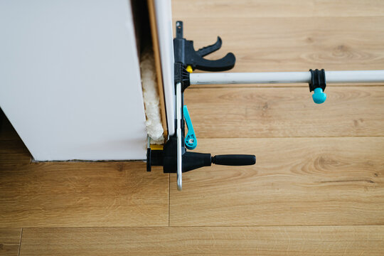 Close up on clamps on door frame during home renovation.