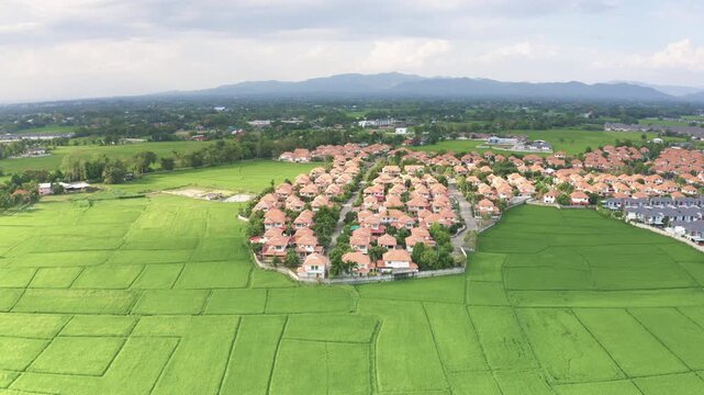 Residential land and houses in housing development project in San Sai District, Chiang Mai, Thailand, photographed in March 2021. Represents modern suburban lifestyle in Northern Thailand.