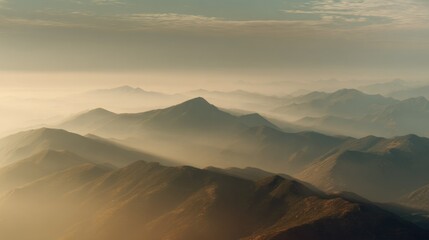 Serene Mountain Landscape at Sunrise with Soft Fog and Misty Atmosphere Overrolling Hills and Peaks in the Distance