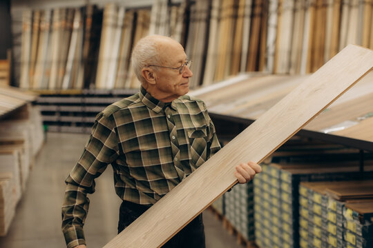Senior man selecting wood planks for home improvement