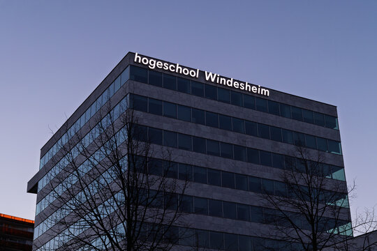 Modern architecture of Hogeschool Windesheim university building at night with glowing sign under a clear dark blue sky. Almere, Netherlands. 14 March 2026.