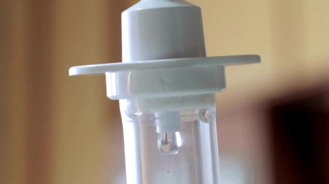 drip in focus Closeup footage of a slow pan down of the IV drip set on IV pole in a black background Intravenous saline solution Slow move around IV