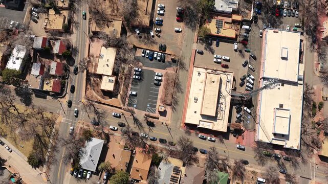 A high-angle drone perspective looks directly down on the iconic adobe rooftops and city streets of Santa Fe. This 4K view highlights the unique urban geometry of the American Southwest.