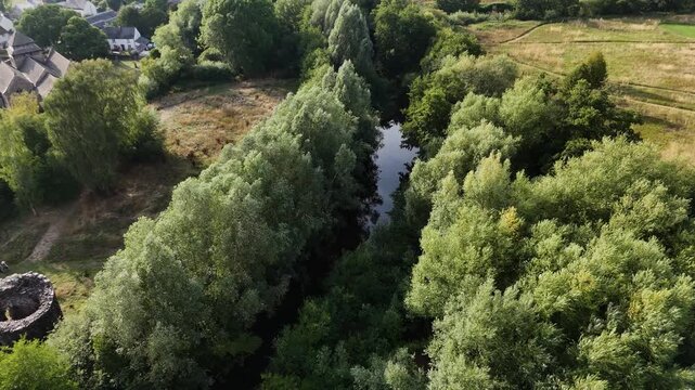 Skenfrith Herefordshire flight along the river showing castle tower,village and fields on bright sunny Summer Day