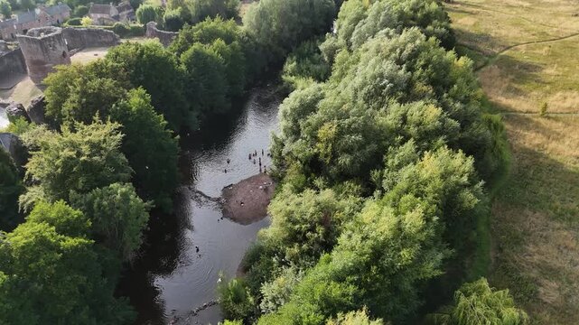Skenfrith Castle Herefordshire flight along the river adjacent to the majestic castle ruins on the Welsh border on bright sunny Summer Day