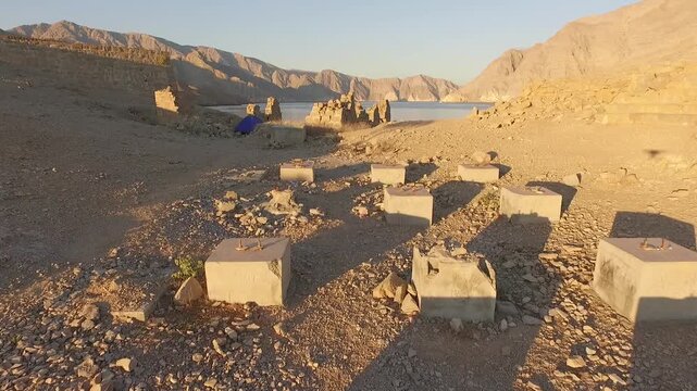 Drone flying across Telegraph Island ruins and camping tent in the Strait of Hormuz Oman near Iran revealing remains of the historic British telegraph station and remote island landscape.