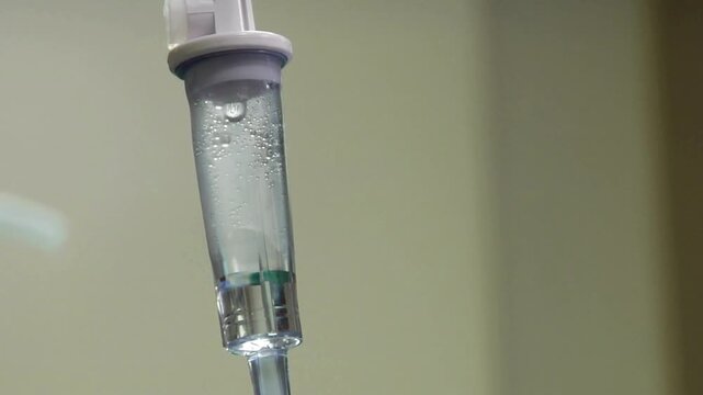 treatment for patient Close up of drops falling from saline liquid bag or IV bag is the infusion of liquid substances directly into a vein Close-up of
